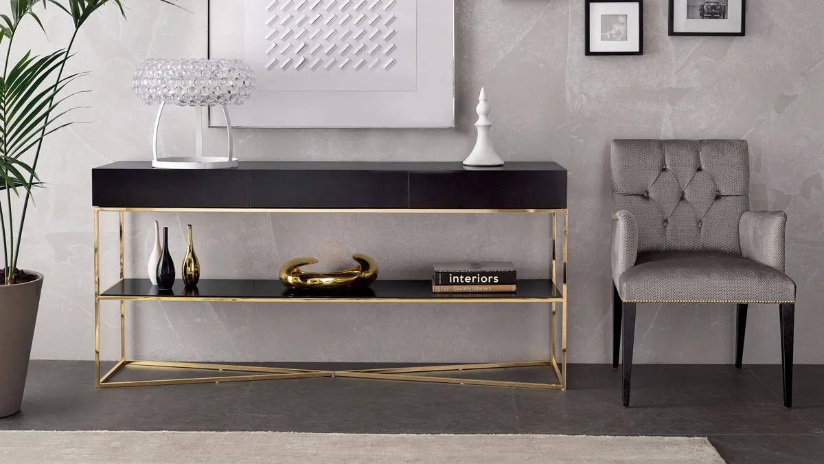 Armchair with tufted back, a gold plated metal base console with wooden drawers in a classic contemporary style
