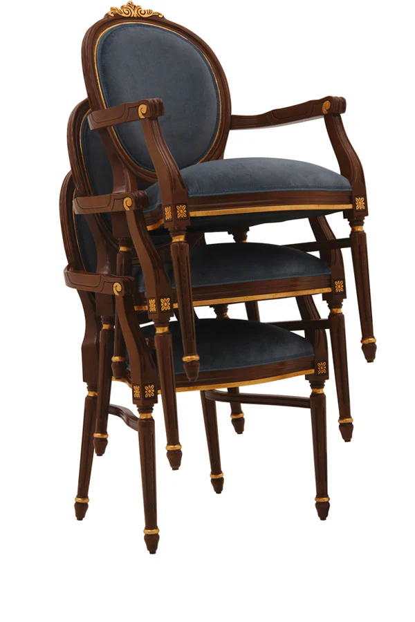 Three stacked classic dining armchairs with wooden frames in walnut finish, enhanced by gold leaf accents and upholstered in deep blue velvet.