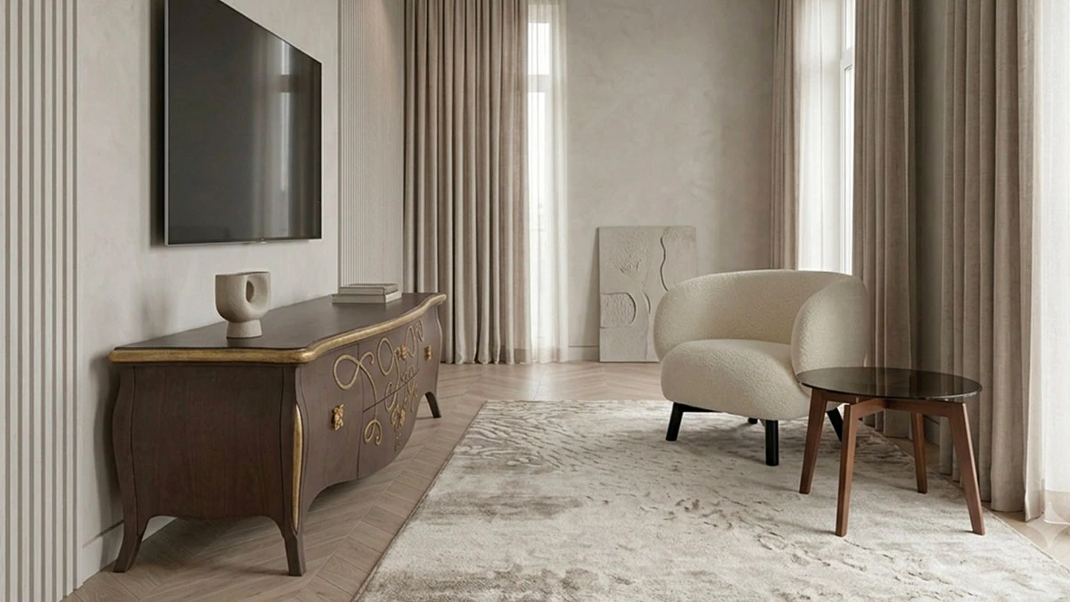 On the left is a hand-carved solid wood TV stand in the Baroque style. A modern television sits on top of it. On the right is a small white armchair in a modern style and a round, four-legged coffee table in a modern style.