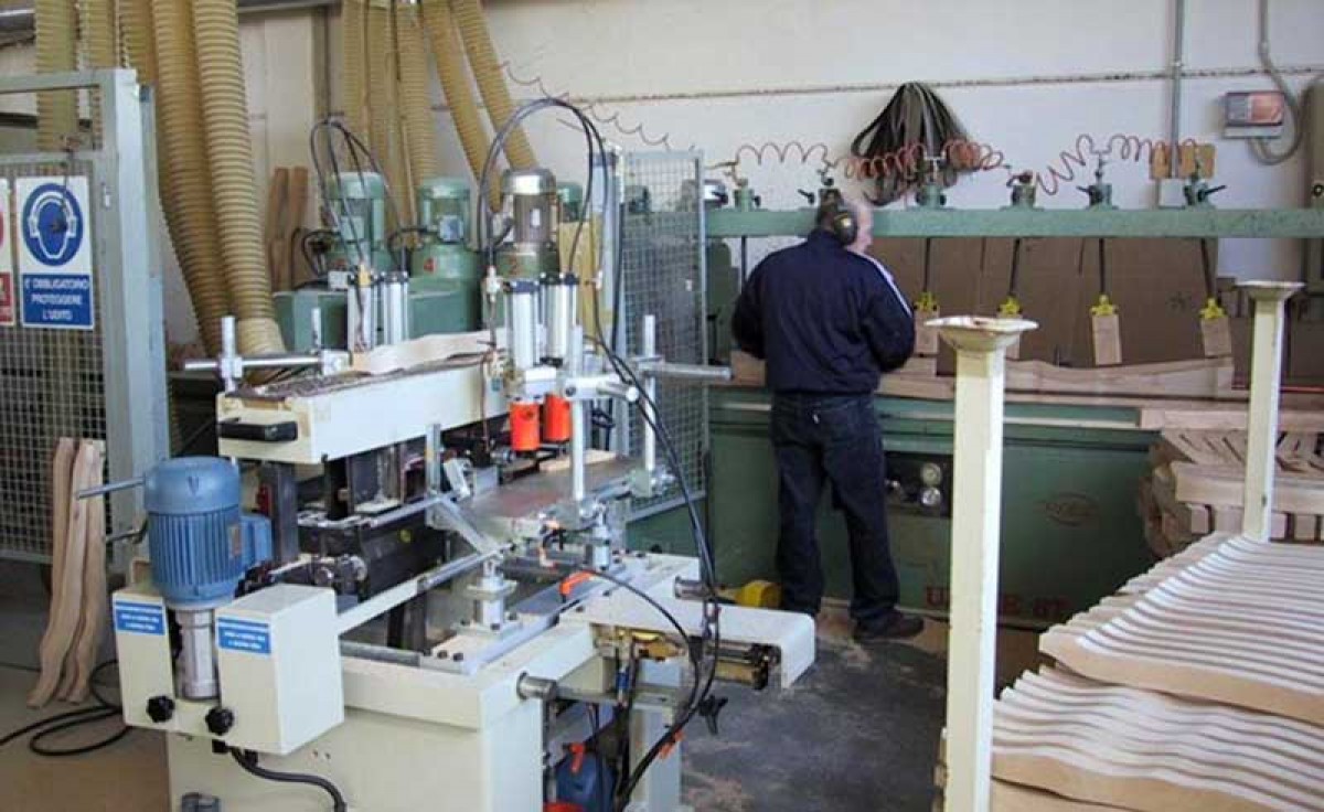 Operator at Sevensedie in Italy milling a wooden chair