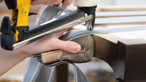  A Craftsman carving a chair at Sevensedie in Italy
