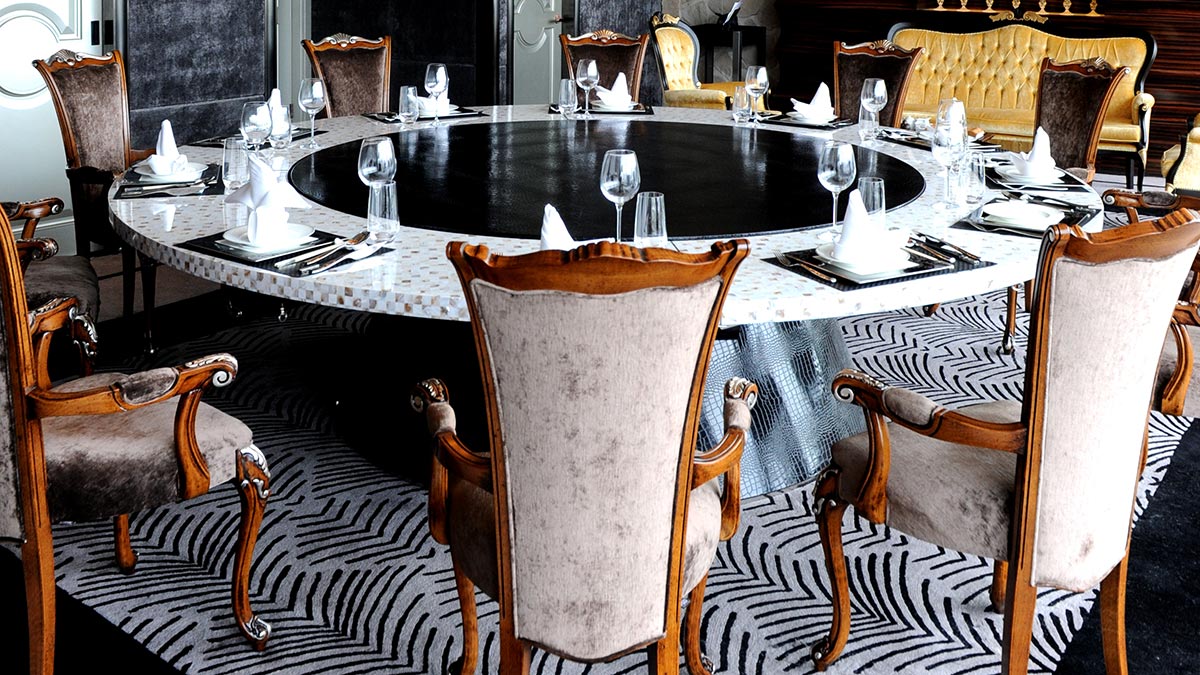 A set of classic Chiara chairs by Sevensedie around a large round table at the Imperial Seal restaurant in Shanghai