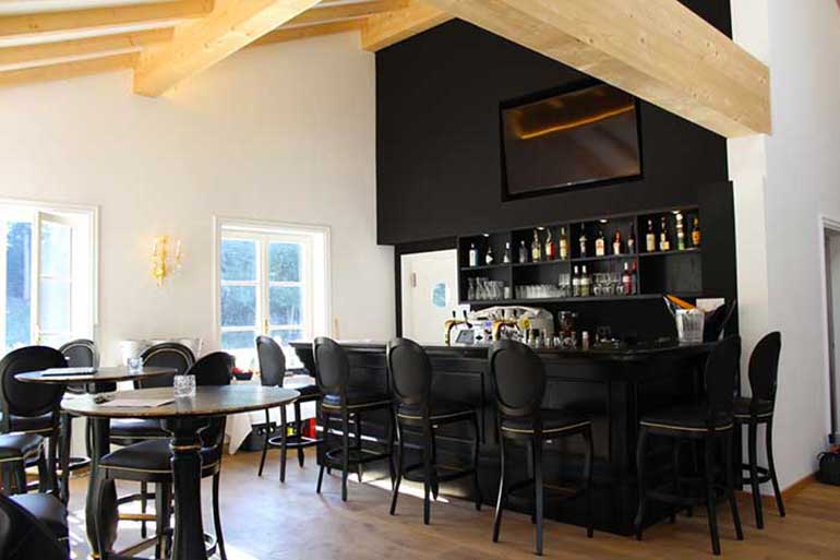 General view of the bar area at the Ludwig restaurant. Classic Louis Style Liberty bar stools in dull black finish upholstered in black vinyl. 