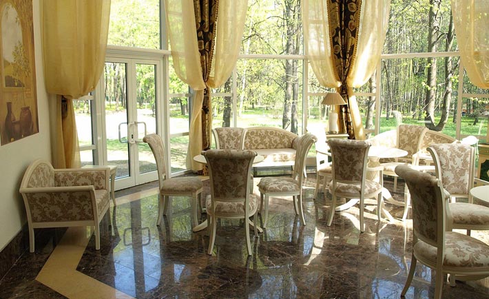 A series of red wooden Luigi chairs in classic italian style around the tables of the Pushkin Restaurant in Moskow, Russia. Italian chairs made by italian traditional manufacturer Sevensedie
